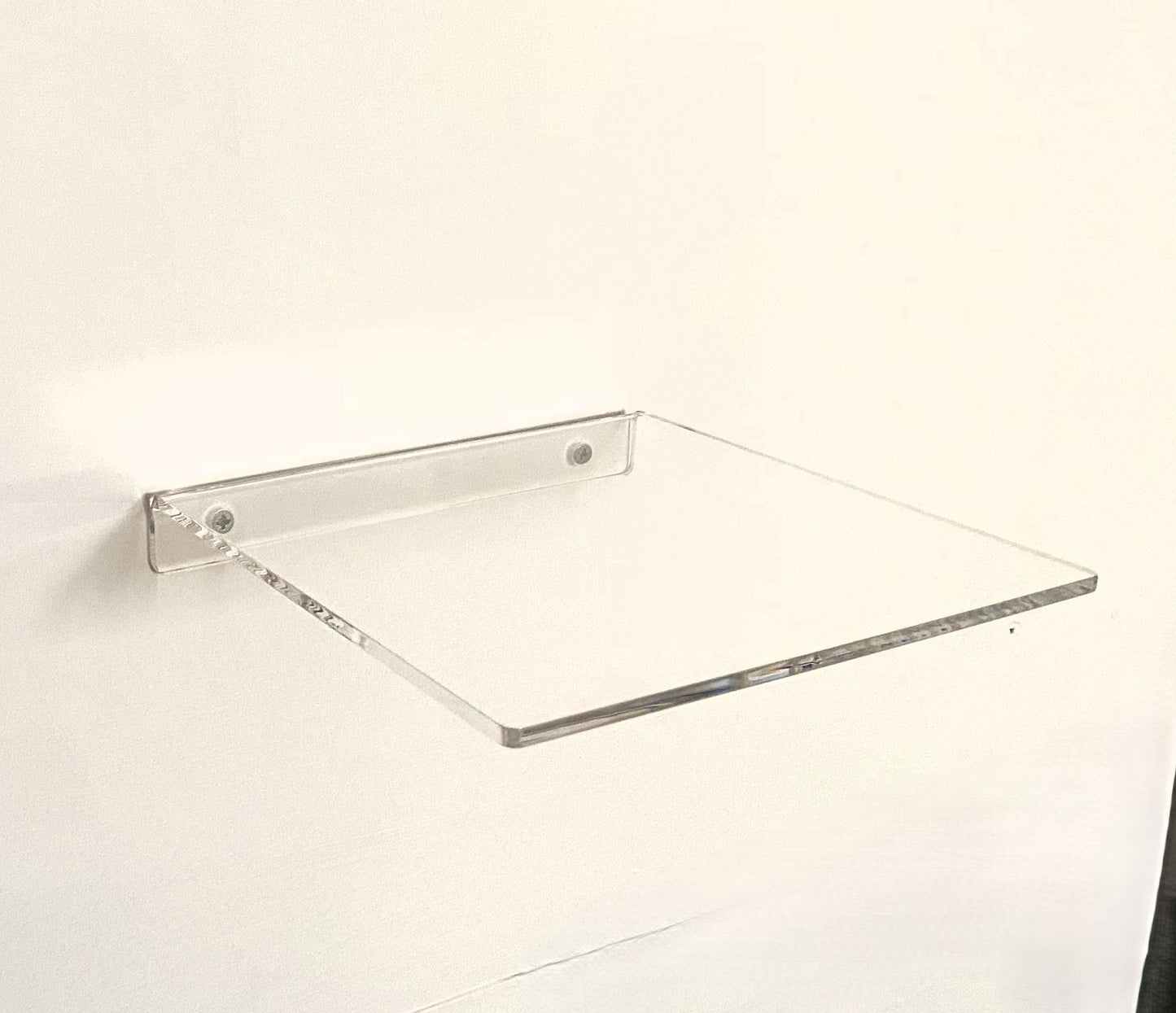 Clear glass shelf on a white background