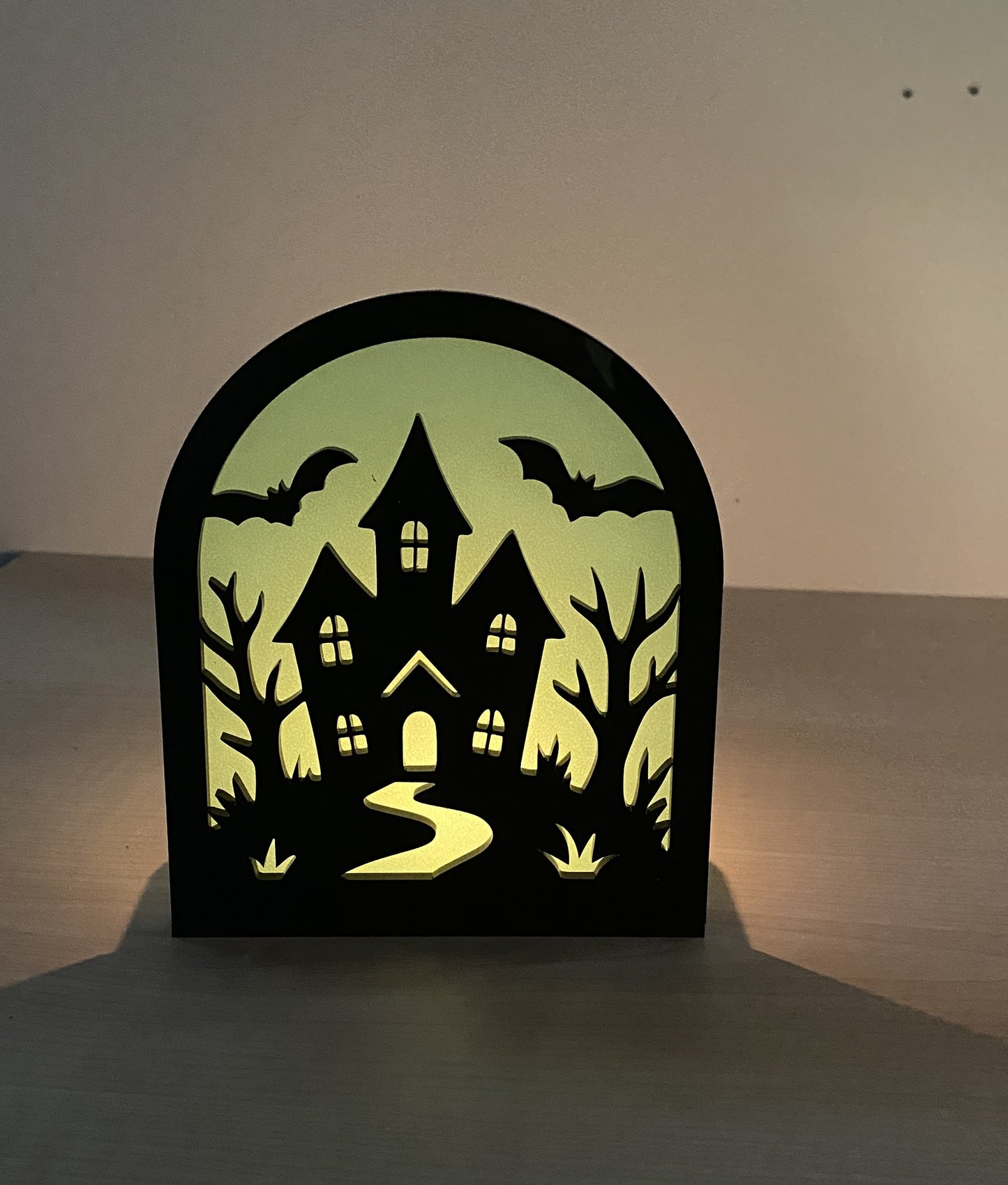 Acrylic haunted house Halloween scene with bats and glowing candle silhouette