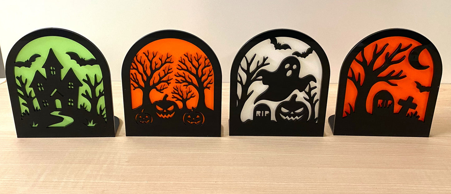 Halloween acrylic scene décor with haunted house, pumpkins, ghosts, and graveyard designs