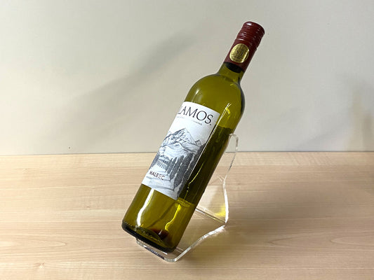 Minimalist home bar or kitchen setup with angled acrylic wine bottle stand in use
