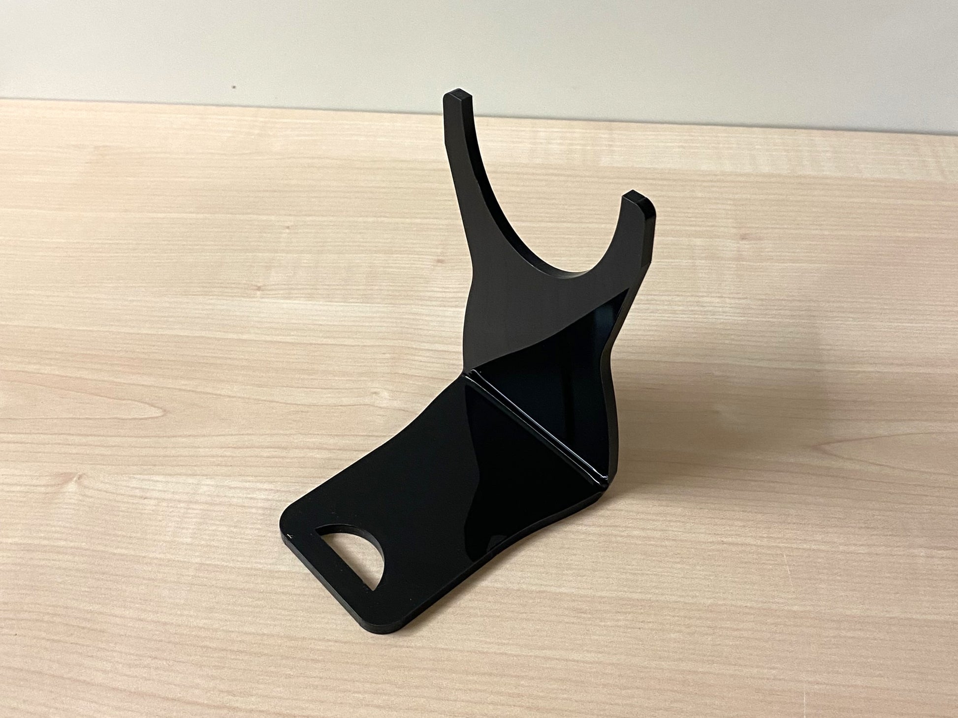 Close-up of angled  black acrylic holder highlighting label visibility and craftsmanship