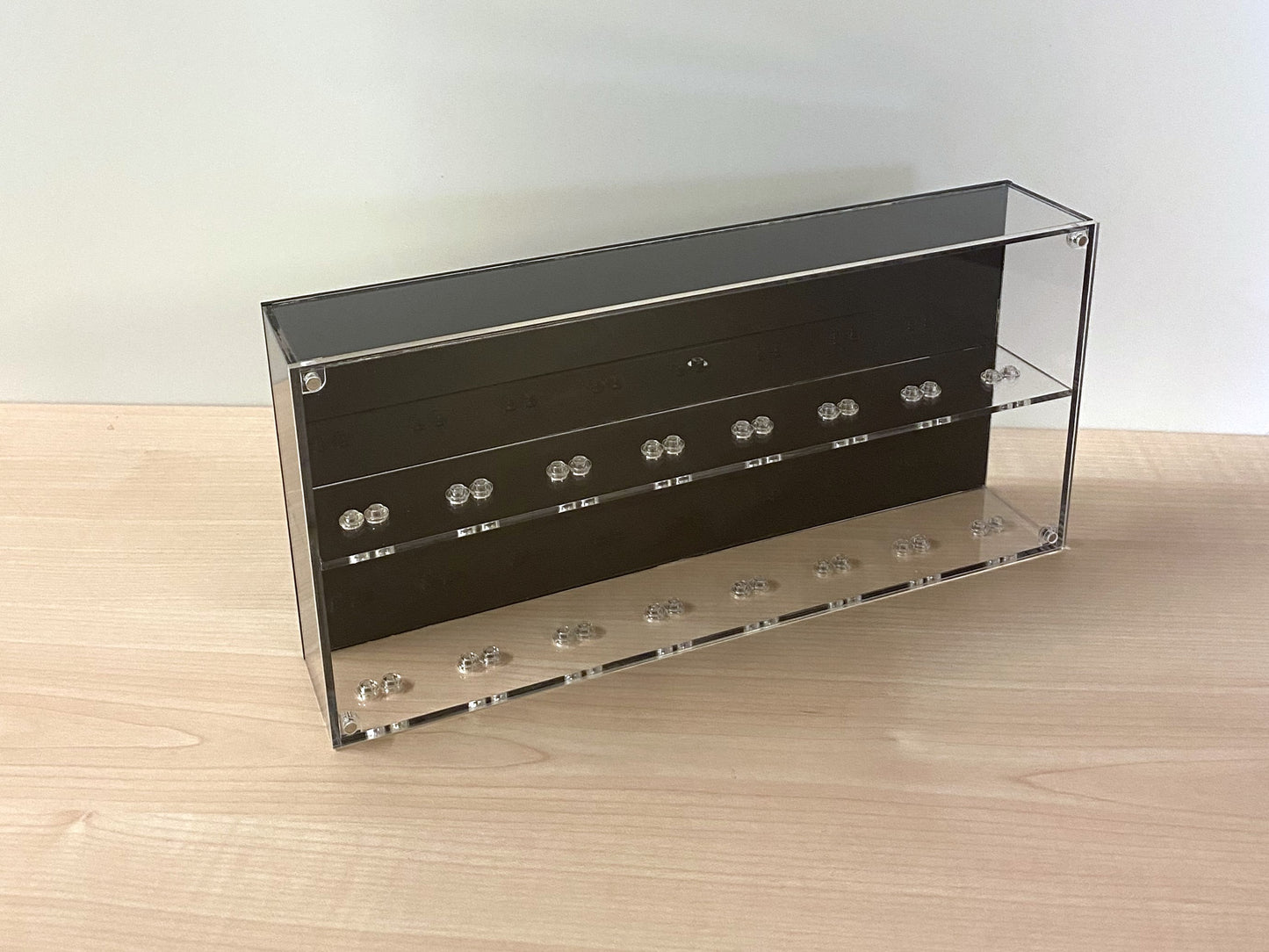 LEGO display case with studded shelves close up